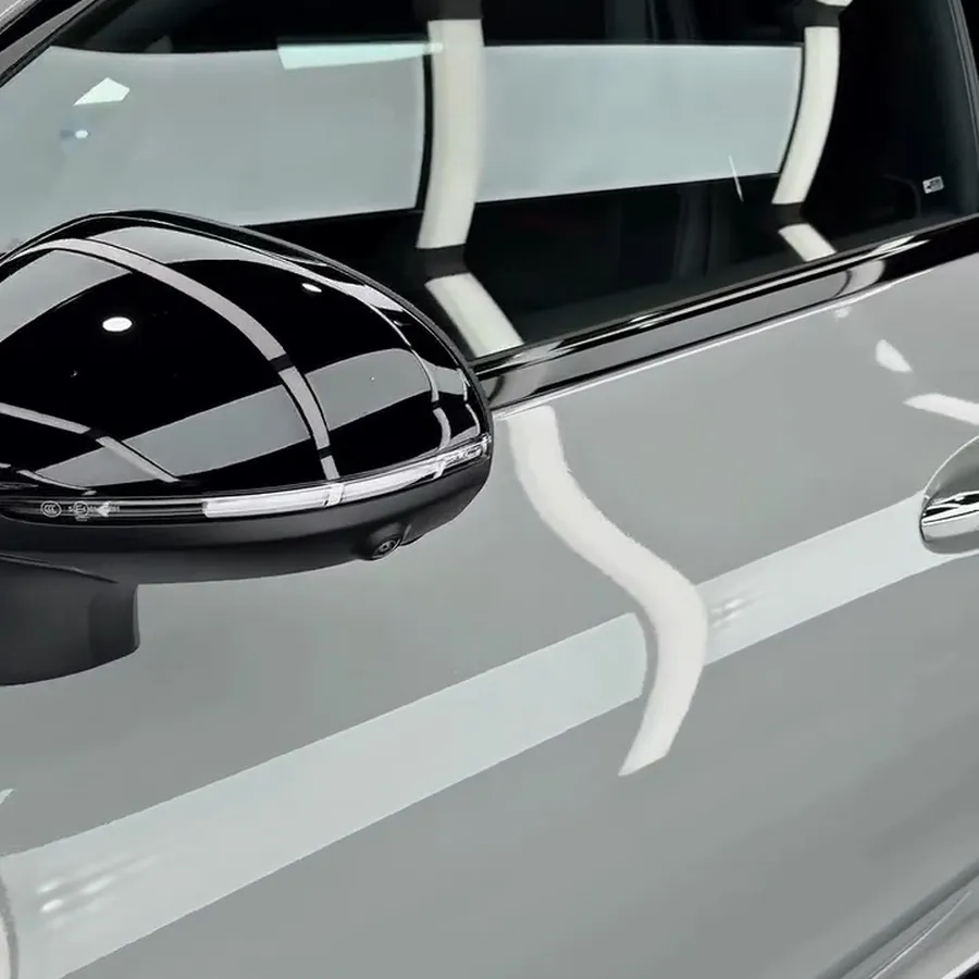 Gloss white door and black mirror cap reflecting the lights