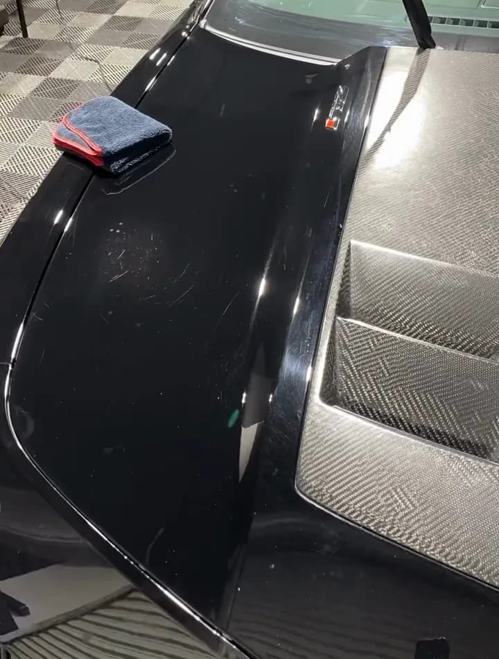 The same black bonnet glossy and clear after machine polishing
