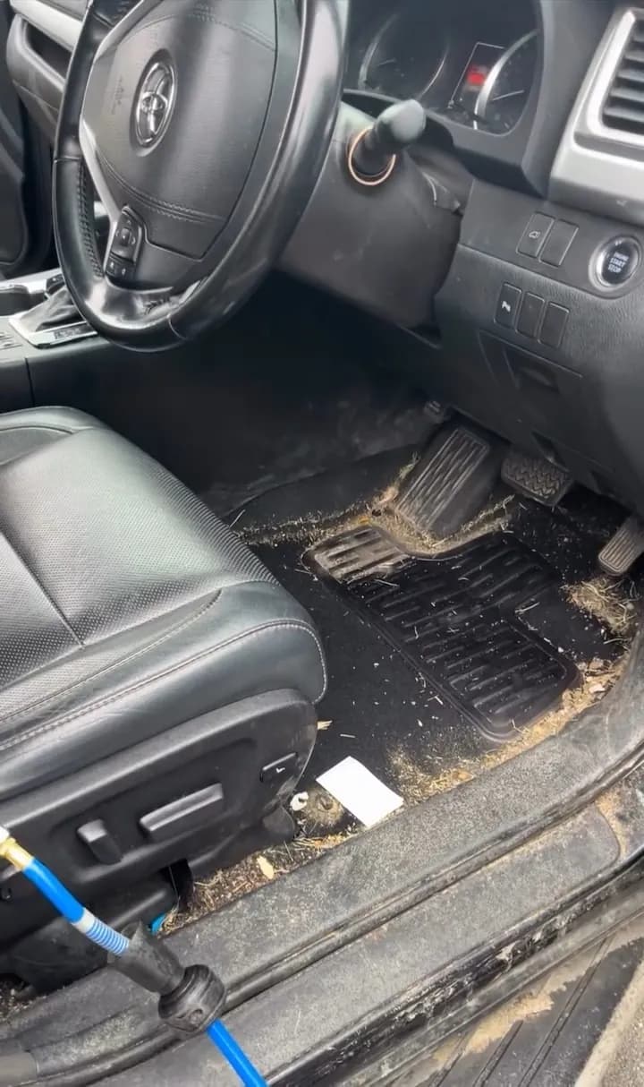 Sandy driver's footwell in a Toyota Highlander before Bay's interior detail