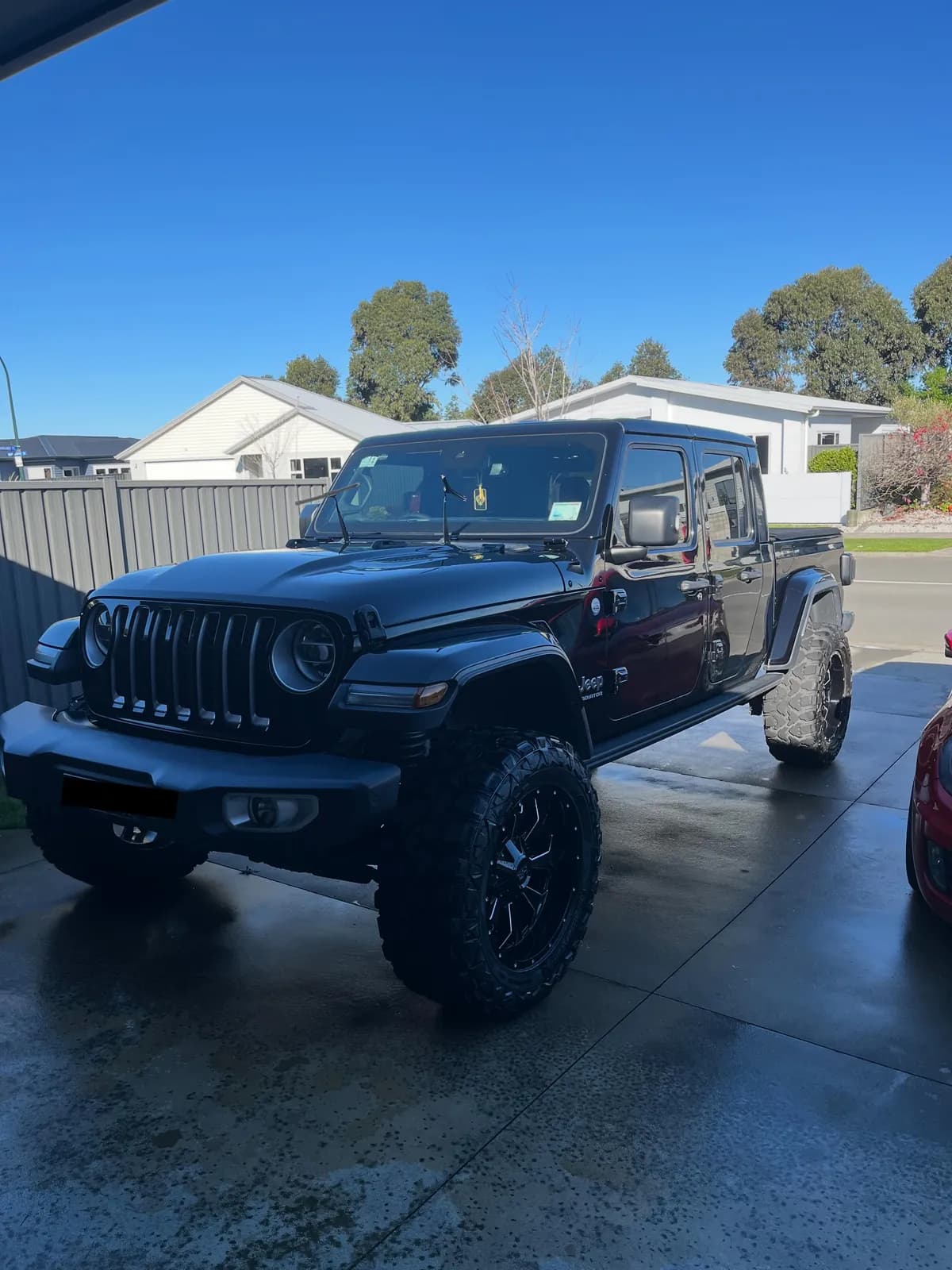Black Jeep Gladiator on a driveway after a full detail by Bay Auto Detailing