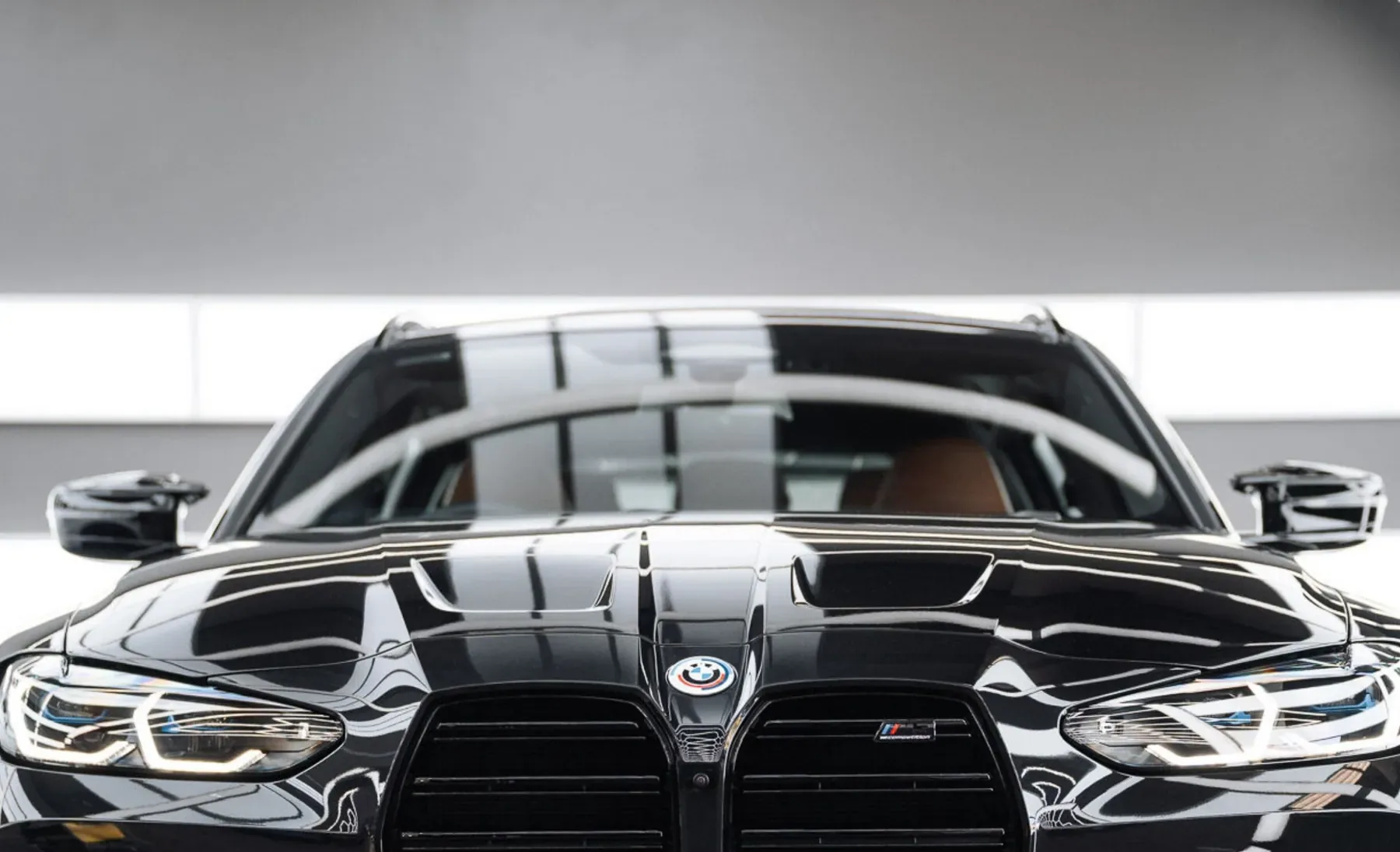 Front of a black BMW with a deep, glossy finish