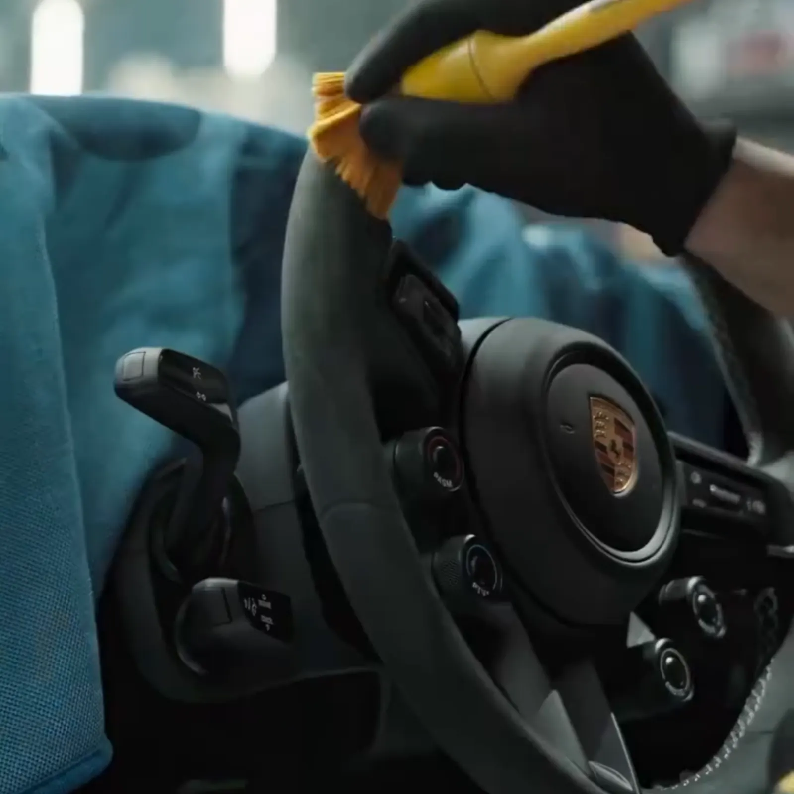 Steering wheel being brushed clean during an interior detail